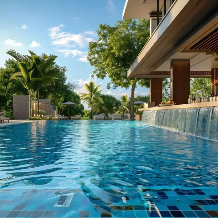 Luxury resort-style swimming pool with waterfall feature beside a modern outdoor bar and tropical landscaping.