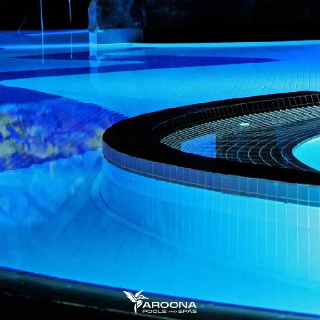 Night view of illuminated luxury concrete pool with LED lighting and tiled finish in Hunters Hill NSW